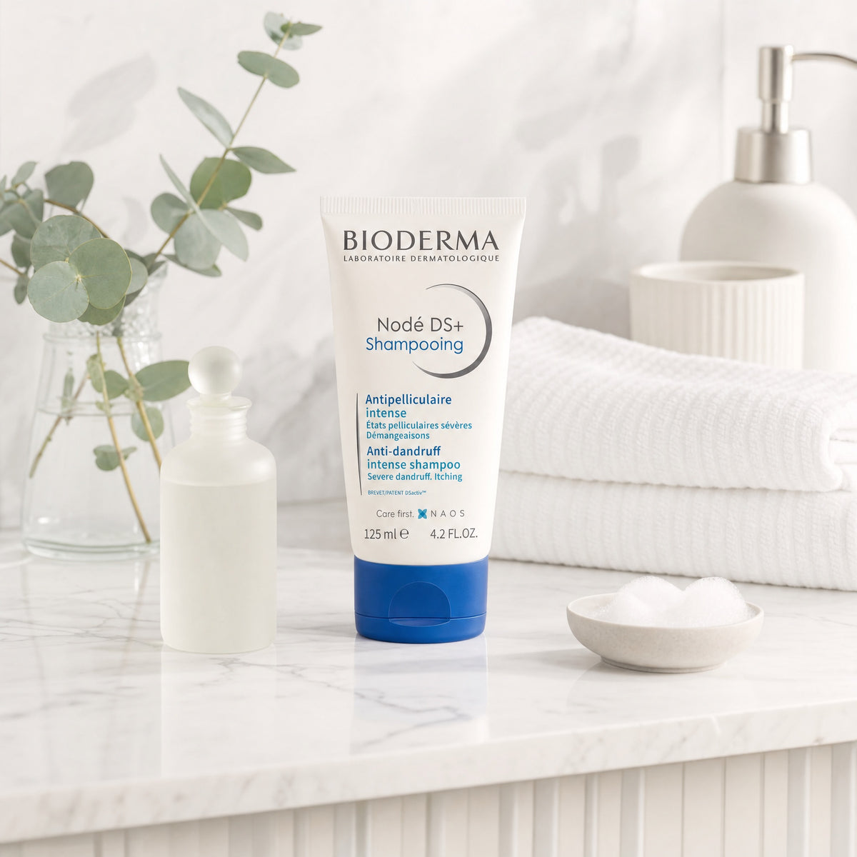 Bioderma Nodé DS+ Shampoo 125ml in a modern bathroom setting for severe dandruff and itchy scalp care.